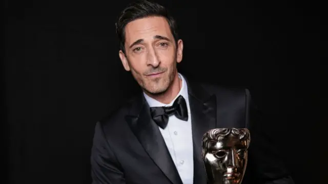 Adrien Brody, winner of the Leading Actor Award for 'The Brutalist', poses backstage during the EE BAFTA Film Awards 2025 at The Royal Festival Hall on February 16, 2025 in London, England