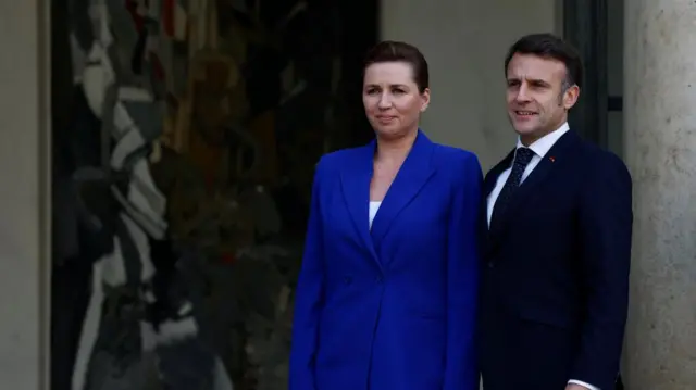 Denmark's Prime Minister Mette Frederiksen stands next to Macron