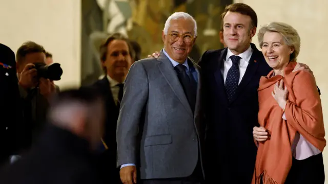 Antonio Costa, Emmanuel Macron and Ursula von der Leyen smile as a their picture is taken