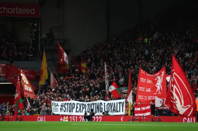 Liverpool fans with 'Stop Exploiting Loyalty' banner