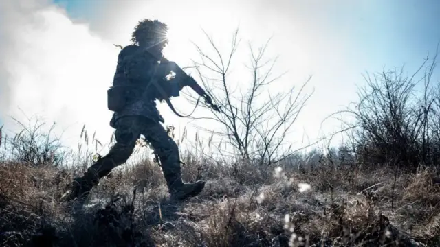 A Ukrainian soldier holding what appears to be a rifle attends combat drills outside of the Pokrovsk, Ukraine on February 13, 2025