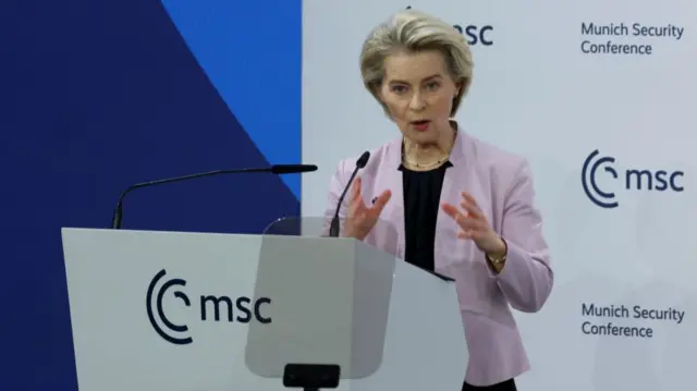 Von Der Leyen at a podium at the Munich Security Conference.