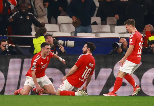 Benfica's Orkun Kokcu celebrates scoring their third goal with teammates