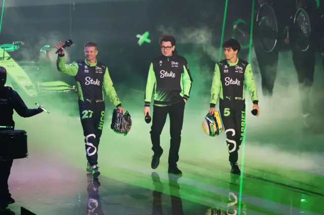 Nico Hulkenberg, Mattia Binotto, Gabriel Bortoleto walk out on stage at O2 Arena