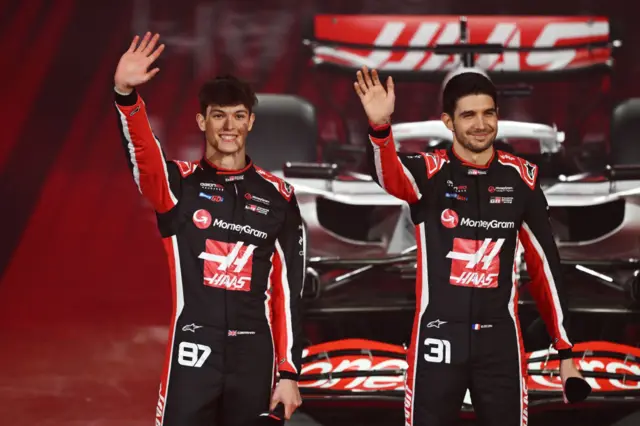 Haas drivers wave to the crowd at the O2 Arena