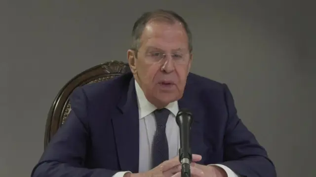 Lavrov speaks into a microphone