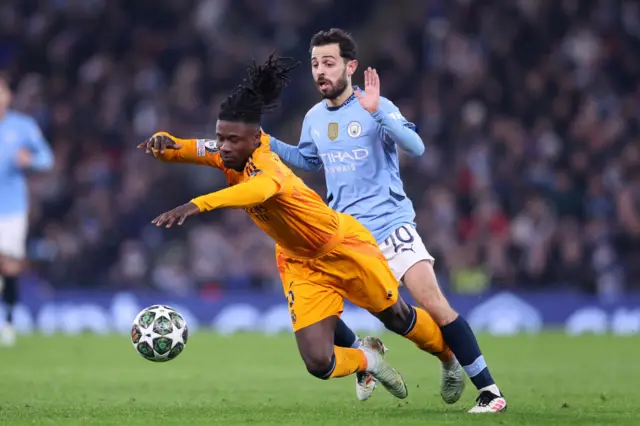 Eduardo Camavinga of Real Madrid is challenged by Manchester City's Bernardo Silva