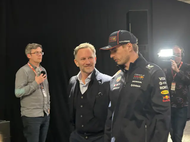 Christian Horner and Max Verstappen walk through the media centre in the O2