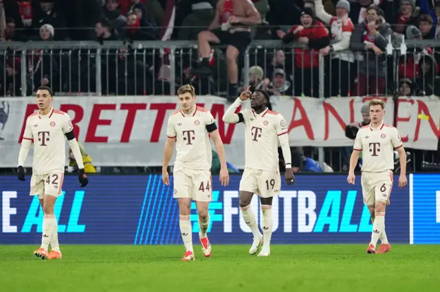 Bayern players walk back to kick off after Davies' goal