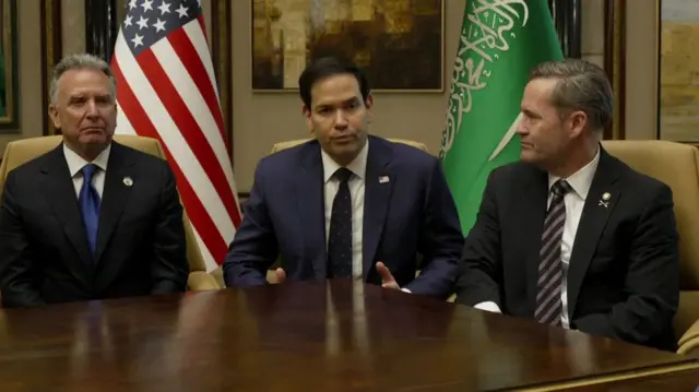 Marco Rubio (centre) speaking a short time ago, with Middle East envoy Steve Witkoff  (left), and National Security Advisor Mike Waltz