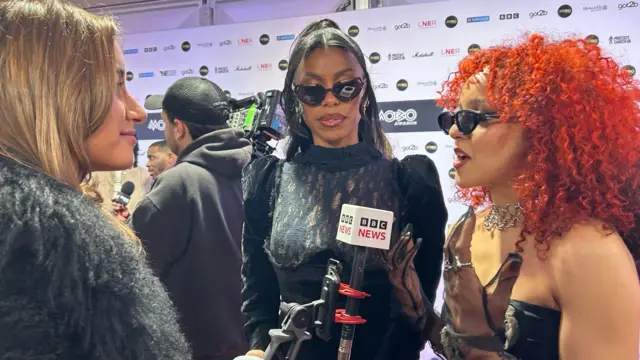 Lola Schroer talking to the Nova Twins on the Mobos red carpet