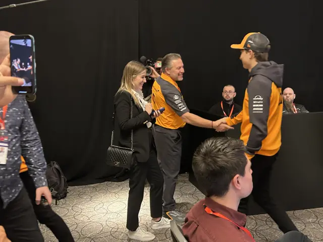 Zak Brown shakes hands with Oscar Piastri