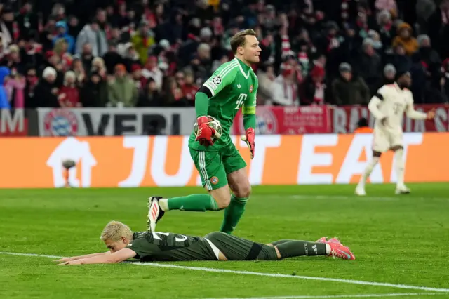 Maeda lies on the floor as Neuer smiles with relief