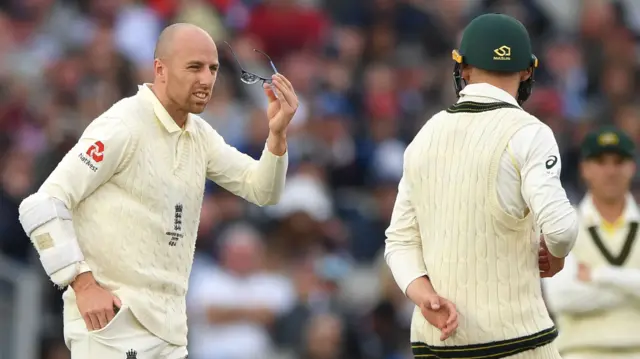 Jack Leach holding his glasses