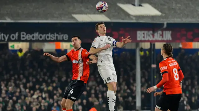 Luton and Plymouth players go up for a header