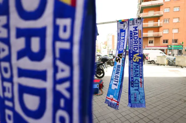 A merchandise stall selling half and half matchday scarves.