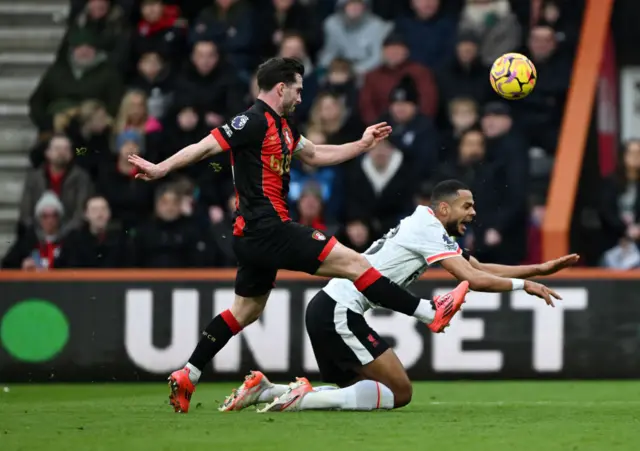 Lewis Cook challenges Cody Gakpo