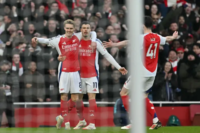 Martin Odegaard (L) celebrates