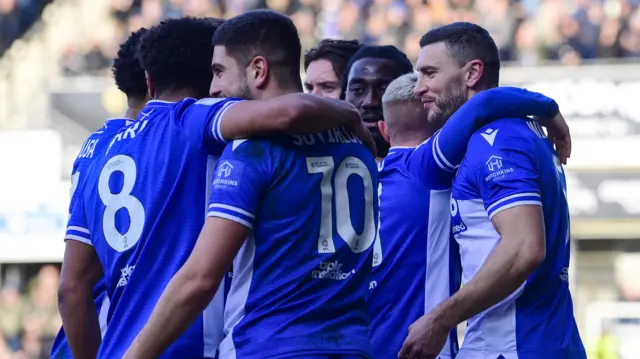 Bristol Rovers players hug James Wilson