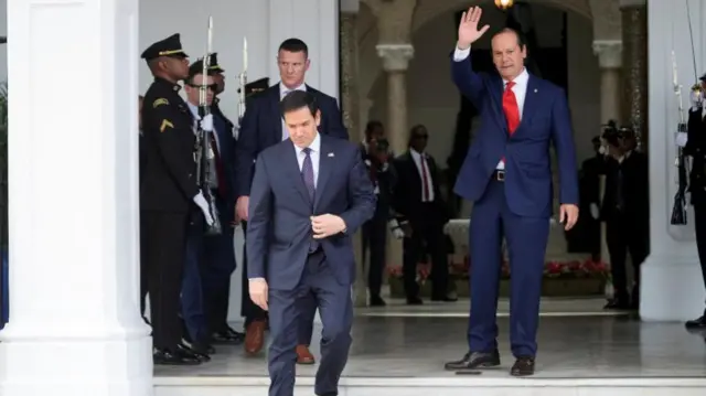 Panama's Foreign Minister Javier Martinez-Acha waves goodbye to US Secretary of State Marco Rubio as he leaves the presidential palace after meeting Panama's president