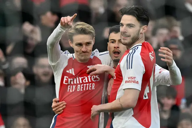 Martin Odegaard (L) celebrates with teammates