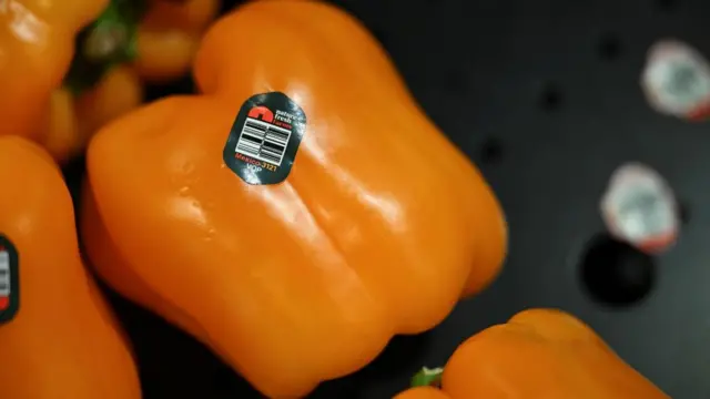 Orange pepper with label showing it is a product of Mexico