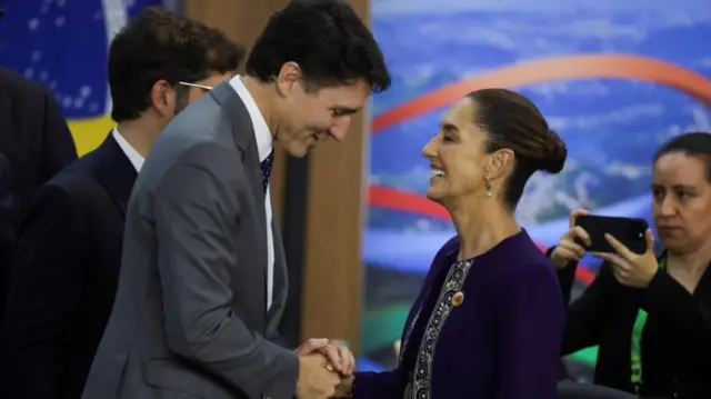 A photo of Justin Trudeau shaking Claudia Sheinbaum's hand