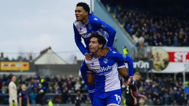 Lino Sousa jumps on Isaac Hutchinson's shoulders after scoring