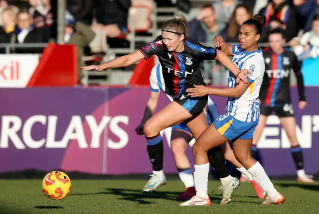 Lexi Potter of Crystal Palace is challenged by Nikita Parris