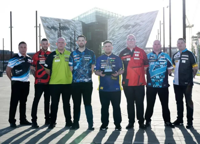 Premier League darts players and the trophy outside the arena in Belfast