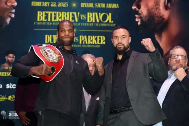 Daniel Dubois holds the IBF heavyweight title over his shoulder and stands next to Joseph Parker