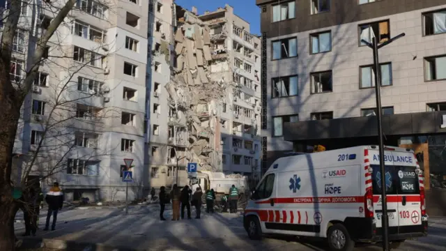 Rescue workers and medics work at the site of a Russian aviation attack on February 20, 2025 in Kherson, Ukraine