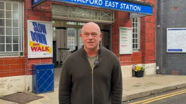 Ross Kemp standing in front of the fictional Walford East tube station on the Eastenders set