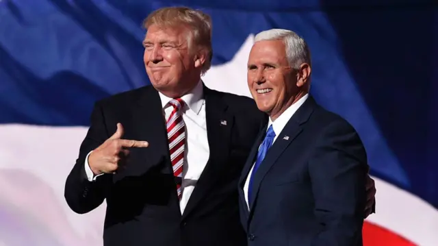 Republican presidential candidate Donald Trump stands with Republican vice presidential candidate Mike Pence and acknowledge the crowd on the third day of the Republican National Convention on July 20, 2016