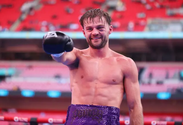 Josh Padley holds up his hand and is wearing a boxing glove