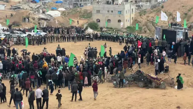 Crowds gather in Khan Younis in Gaza ahead of the release of the bodies of four Israeli hostages. They are standing in a large circle