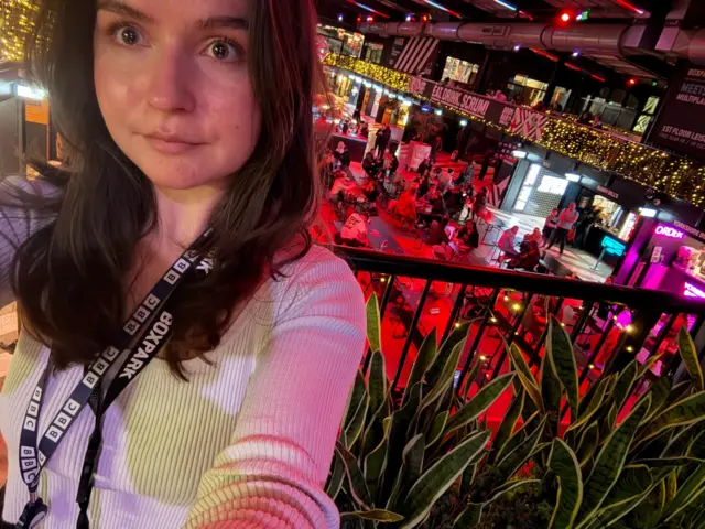 Shola Lee at Boxpark Wembley with tables of people behind her