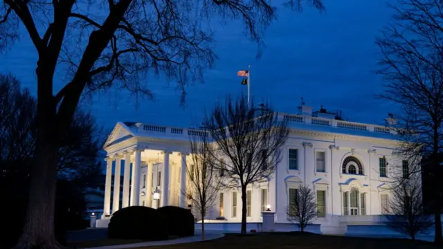 The White House is seen at night time, with snowy background