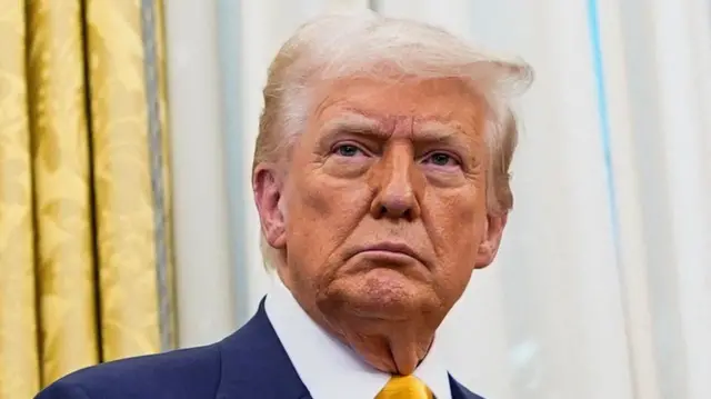 U.S. President Donald Trump stands in the Oval Office of the White House,