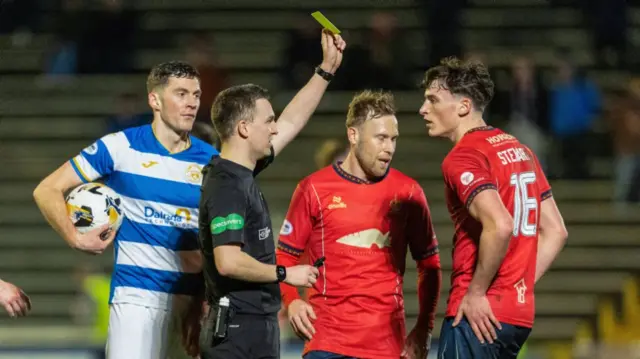 alkirk's Barney Stewart recieves a yellow card from referee Dan McFarlane during a William Hill Championship match between Greenock Morton and Falkirk at Cappielow Park, on February 21, 2025, in Greenock, Scotland. (Photo by Mark Scates / SNS Group)