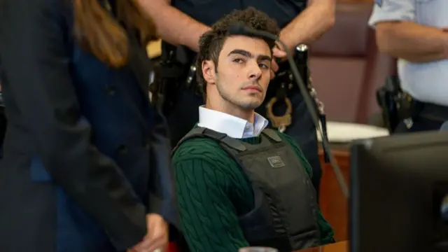 Luigi Mangione sits in court wearing a bulletproof vest