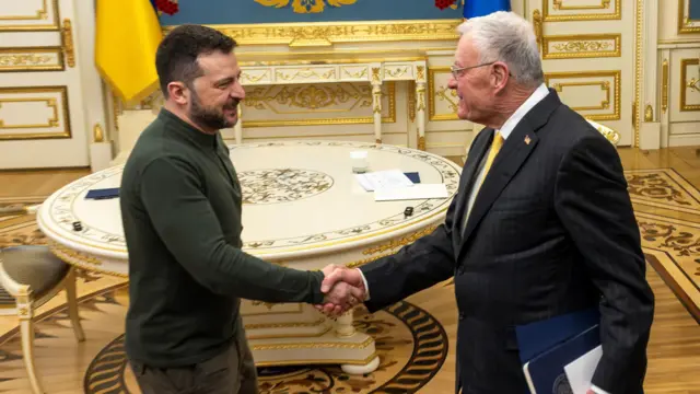 Zelensky shakes hands with Kellogg