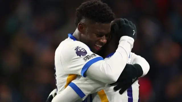 Yankuba Minteh of Brighton & Hove Albion celebrates with Carlos Baleba