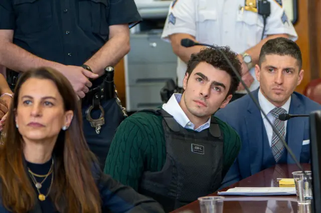 Luigi Mangione, accused killer of US insurance CEO Brian Thompson, sits next to his attorney Karen Friedman Agnifilo in Manhattan Supreme Court