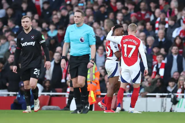 Myles Lewis-Skelly of Arsenal is consoled by Oleksandr Zinchenko