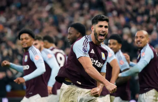 Asensio and Villa players celebrate their late winner