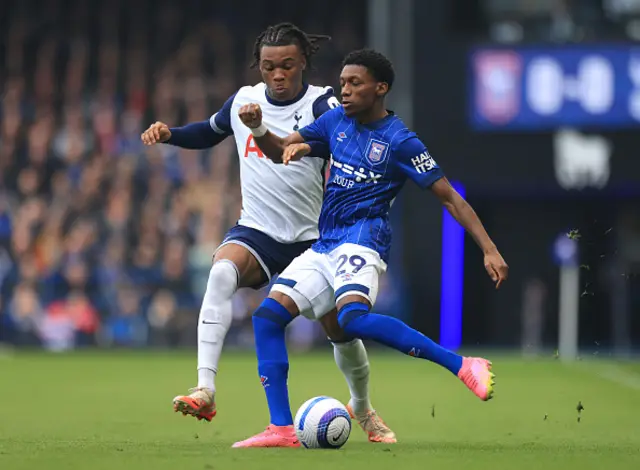 Jaden Philogene of Ipswich Town is challenged by Destiny Udogie