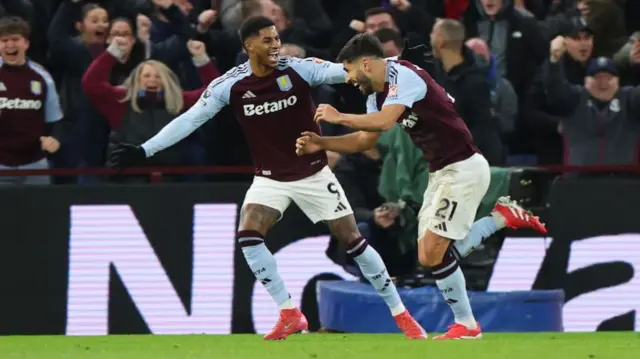 Marco Asensio of Aston Villa celebrates scoring his team's second goal with teammate Marcus Rashford