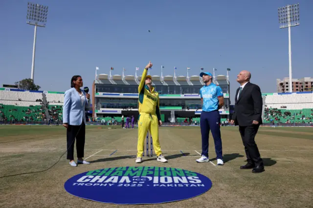 Steve Smith gives the coin a flick with Jos Buttler watching on