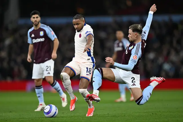 Christopher Nkunku of Chelsea is challenged by Matty Cash